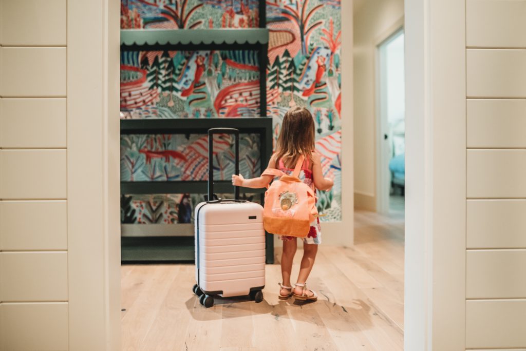 Odette carrying suitcase